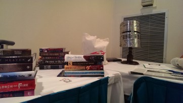 Books and Helm at the party, piled into lots to be given away, along with some bonus Tor goodies.